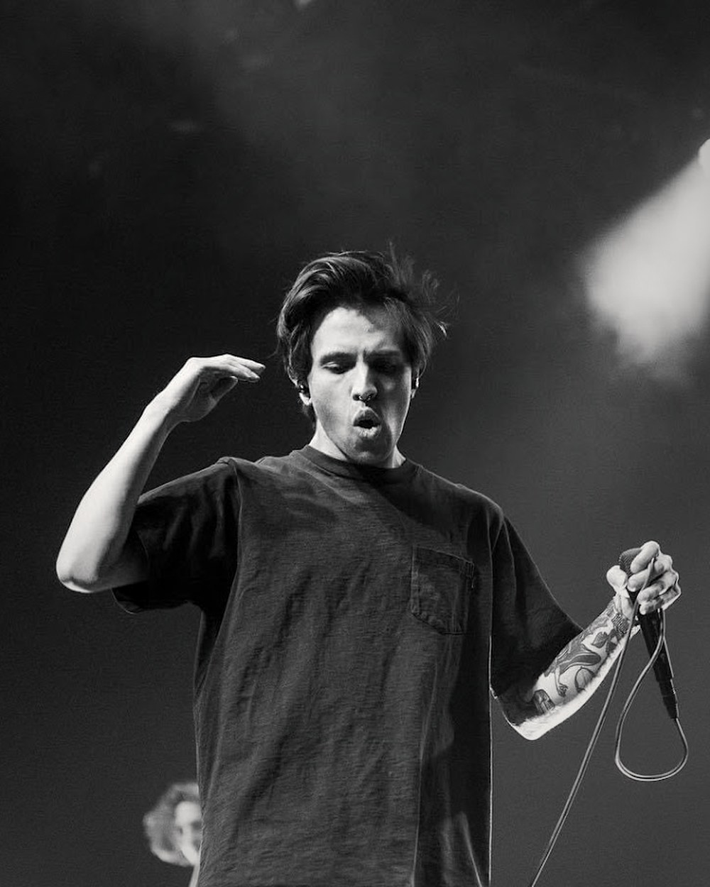 Jacob Wilkes on stage, arm raised