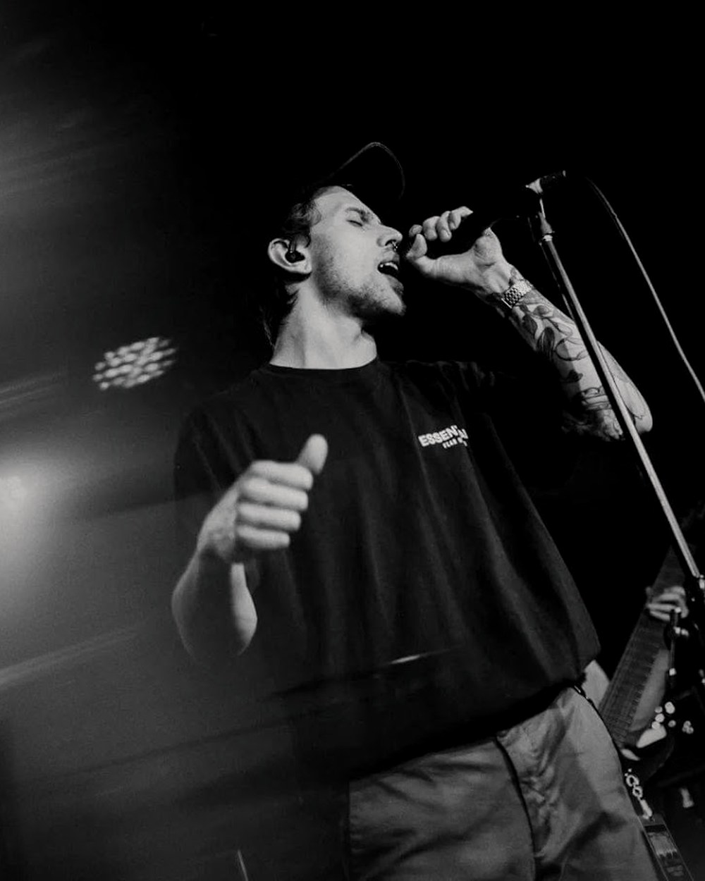 Jacob Wilkes singing under light streaks