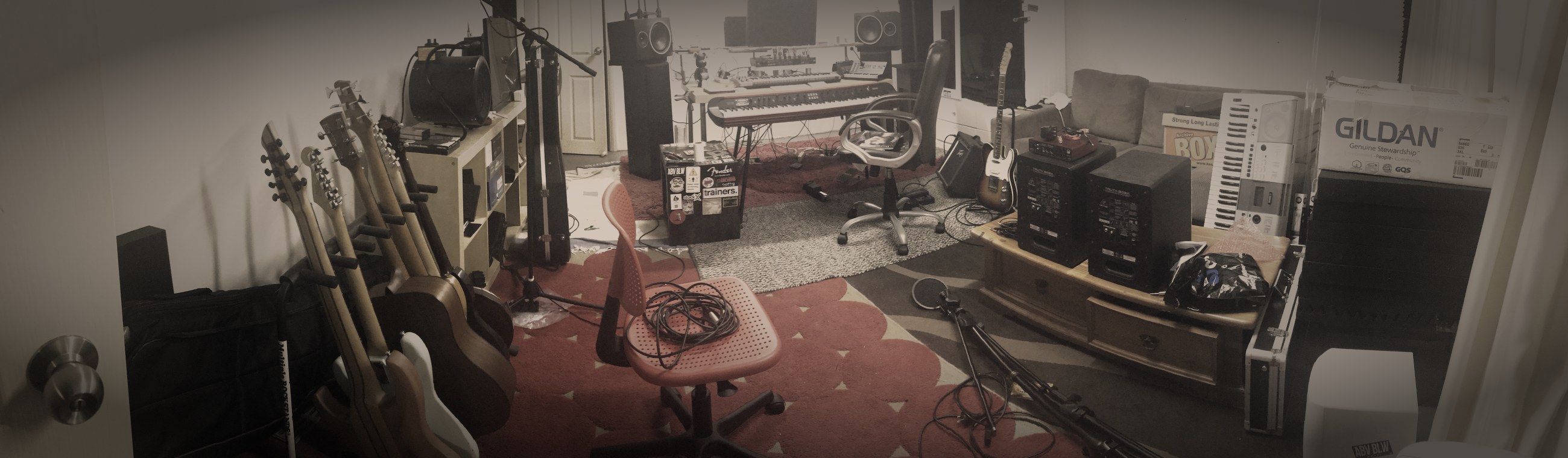 Wide view of the studio room and the guitar wall